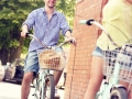 Young man cycling with his girlfriend