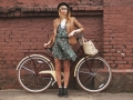 fashionable woman with vintage bike on brick wall background